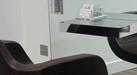 Sleek styling chair and mirror at G R Hair Studio, Truro, England, GB. Modern design for premium hair services.