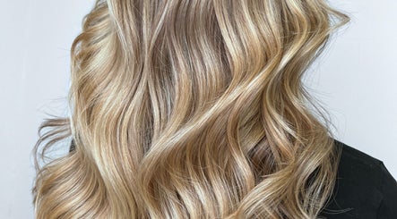 Blonde wavy hairstyle at G R Hair Studio, Truro, England, GB enhancing elegant golden tones.