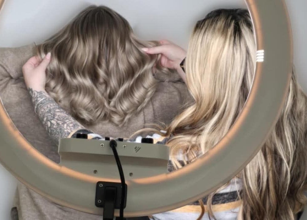 Stylist perfecting waved hair under ring light at G R Hair Studio, Truro, England, GB.