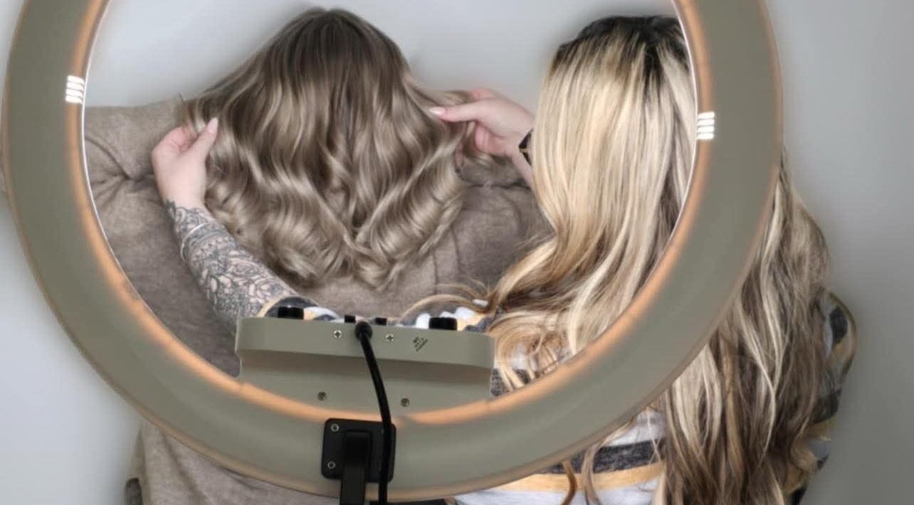 Stylist perfecting waved hair under ring light at G R Hair Studio, Truro, England, GB.