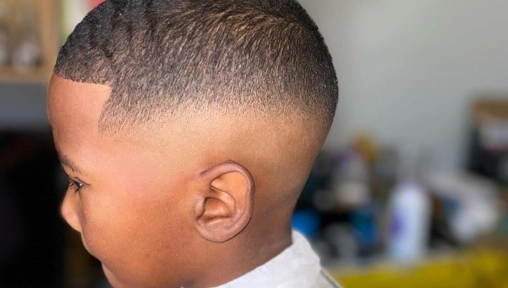 Crisp fade haircut at Incredible Haircuts, Stellenbosch, Western Cape, ZA showcasing expert barber skills.