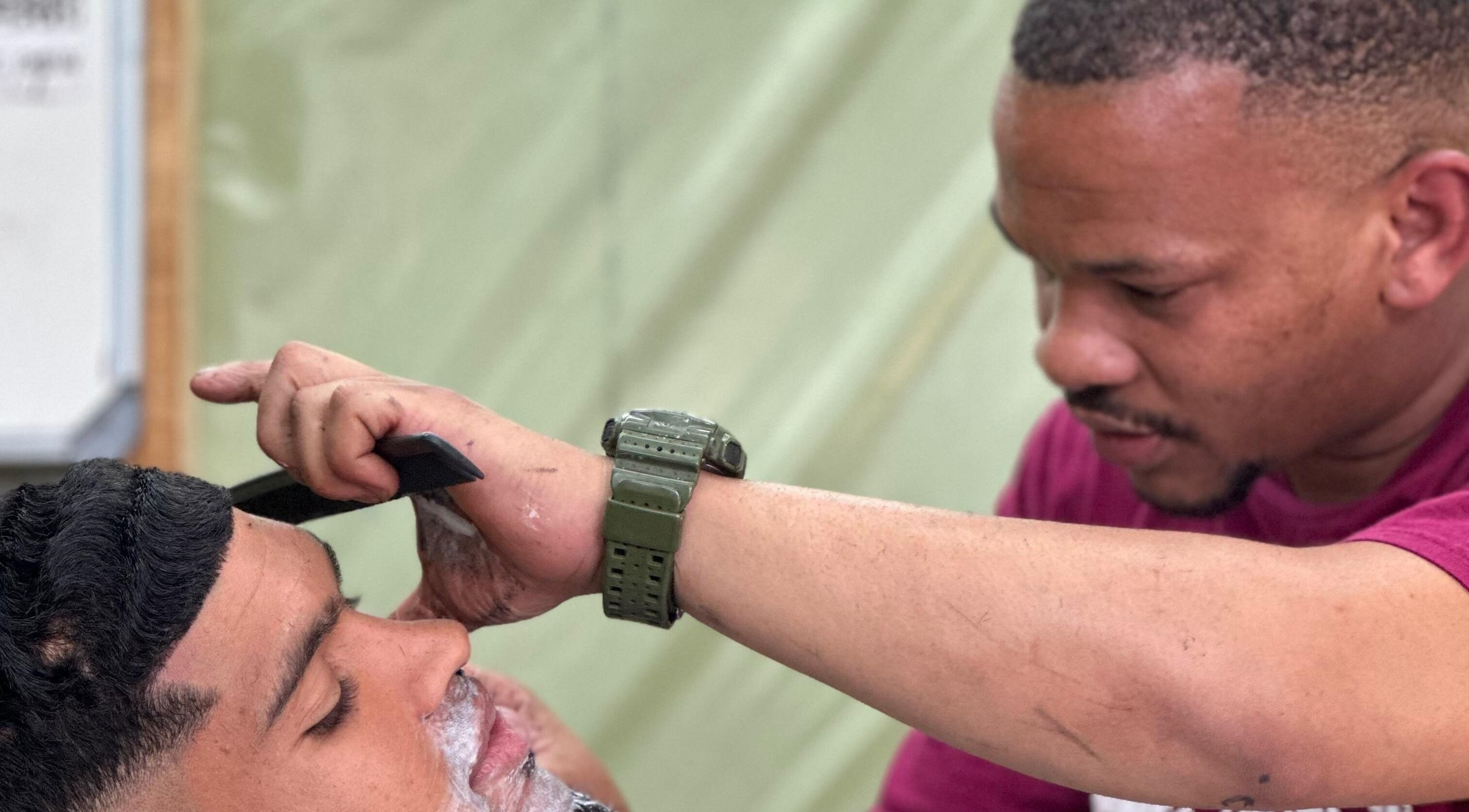 Professional barber at Incredible Haircuts, Stellenbosch, Western Cape, ZA carefully styles a customer's hair.