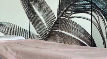 Elegant spa bed at By Atinem, Capelle Aan Den Ijssel, Zuid-Holland, NL with artistic wall design.