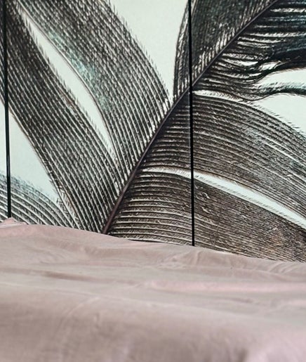 Relaxing treatment bed at By Atinem, Capelle Aan Den Ijssel, Zuid-Holland, NL, with calming wall art.