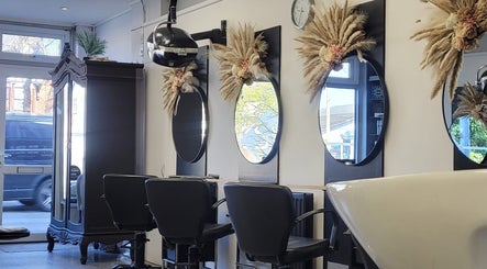 Stylish interior of Melanie Yvonne Hair salon in Chester, England, GB, featuring elegant mirrors and chic chairs.