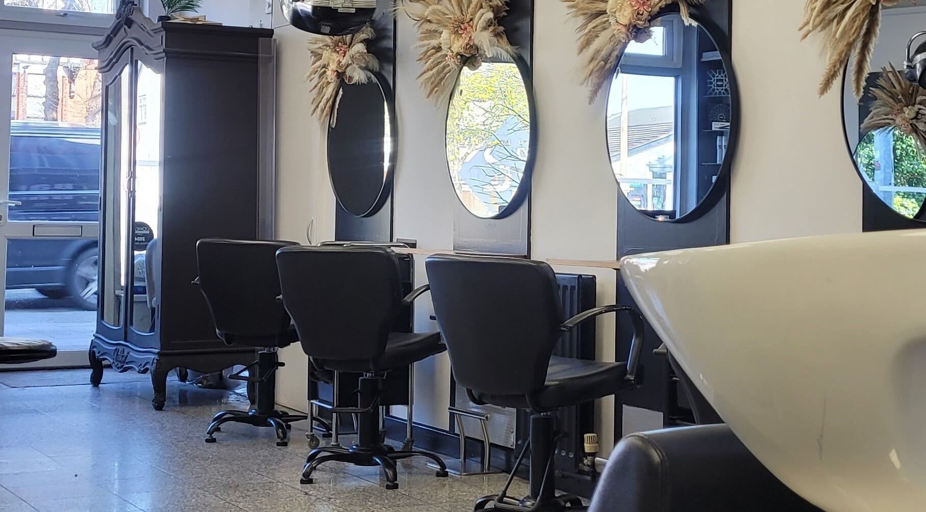 Elegant beauty salon interior at Melanie Yvonne Hair, Chester, England, GB. Features stylish chairs and mirrors.