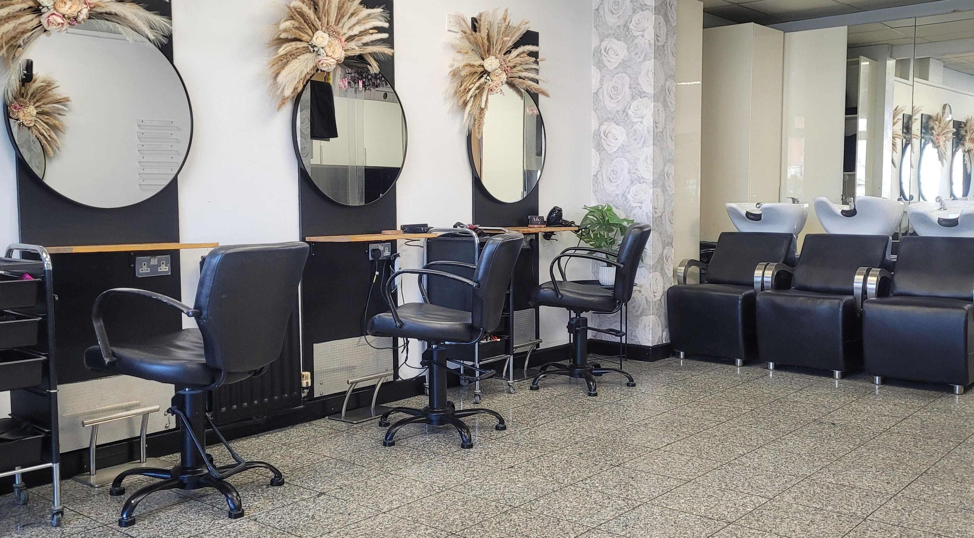 Modern salon interior at Melanie Yvonne Hair in Chester, England, GB with stylish chairs and mirrors.