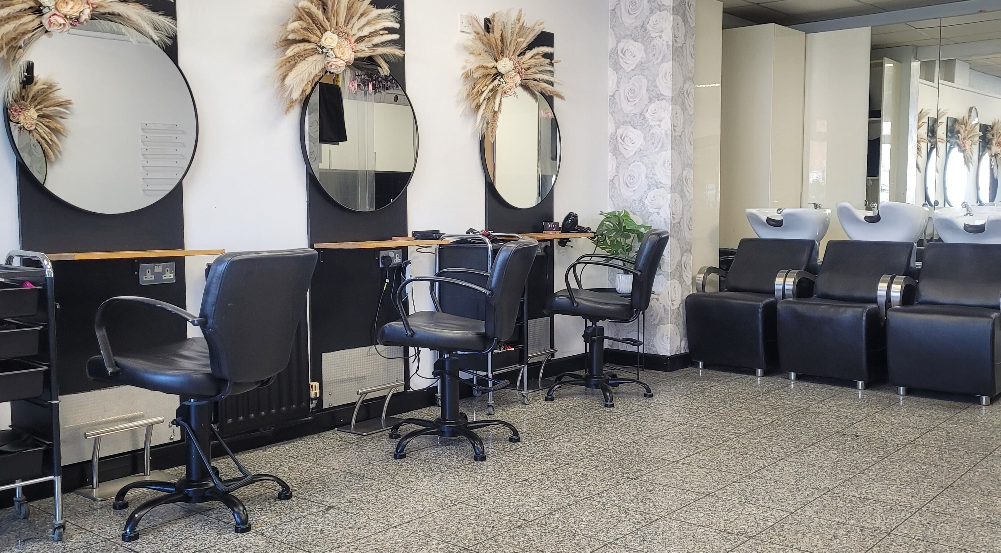 Modern salon interior at Melanie Yvonne Hair in Chester, England, GB with stylish chairs and mirrors.