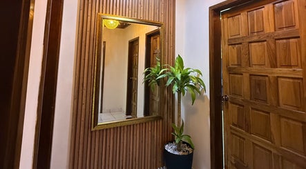 Entrada acogedora en Divinas beauty salon con espejo y planta decorativa. San Pedro Sula, Departamento De Cortés, HN.