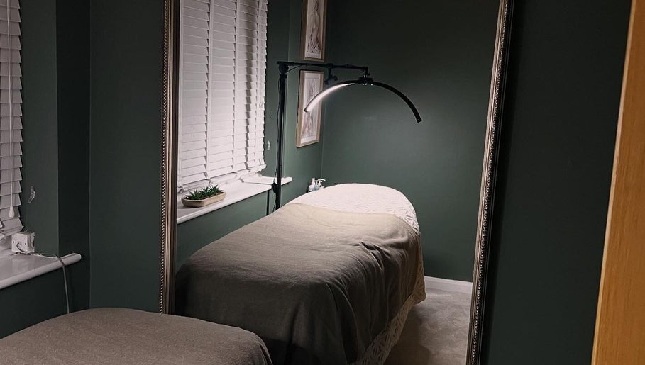 Relaxing treatment room at DANA Skin & Aesthetics, Ripon, England, GB, featuring a cozy bed with soft lighting.
