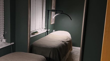Relaxing treatment room at DANA Skin & Aesthetics, Ripon, England, GB, featuring a cozy bed with soft lighting.