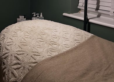 Comfortable treatment bed at DANA Skin & Aesthetics in Ripon, England, GB, ready for a soothing session.