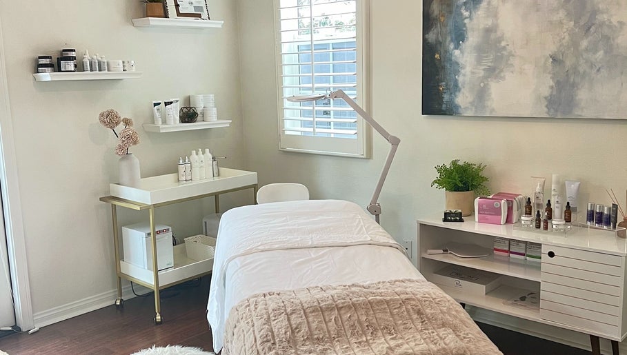 Tranquil treatment room at Refresh Skin, Carlsbad, California, US with a comfortable bed and skincare products.