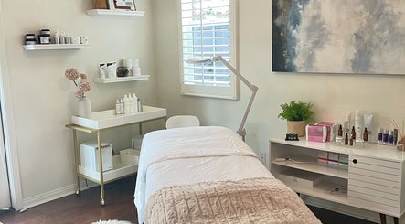 Tranquil treatment room at Refresh Skin, Carlsbad, California, US with a comfortable bed and skincare products.