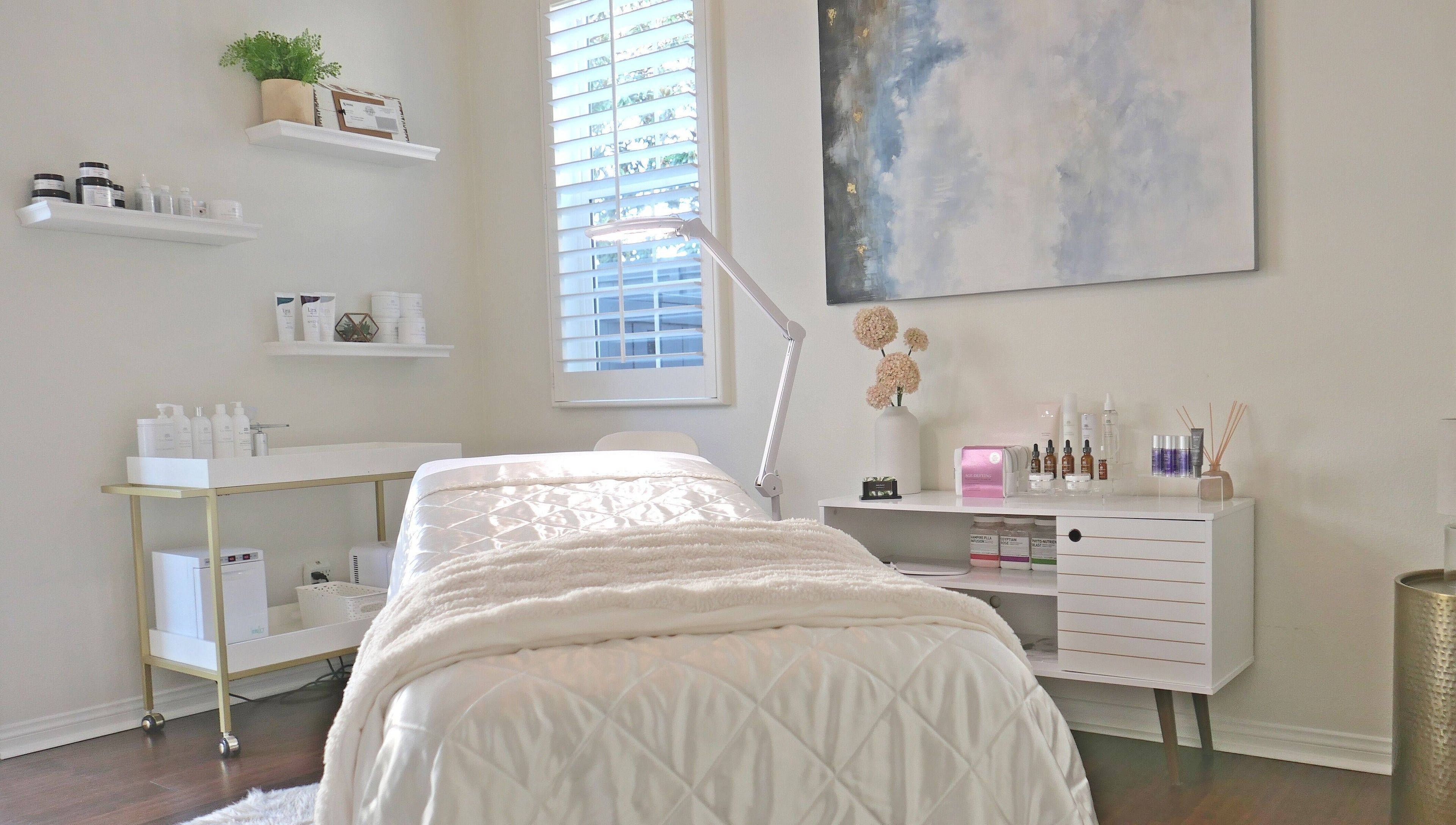 Calm treatment room at Refresh Skin in Carlsbad, California, US, featuring a plush bed and serene decor.