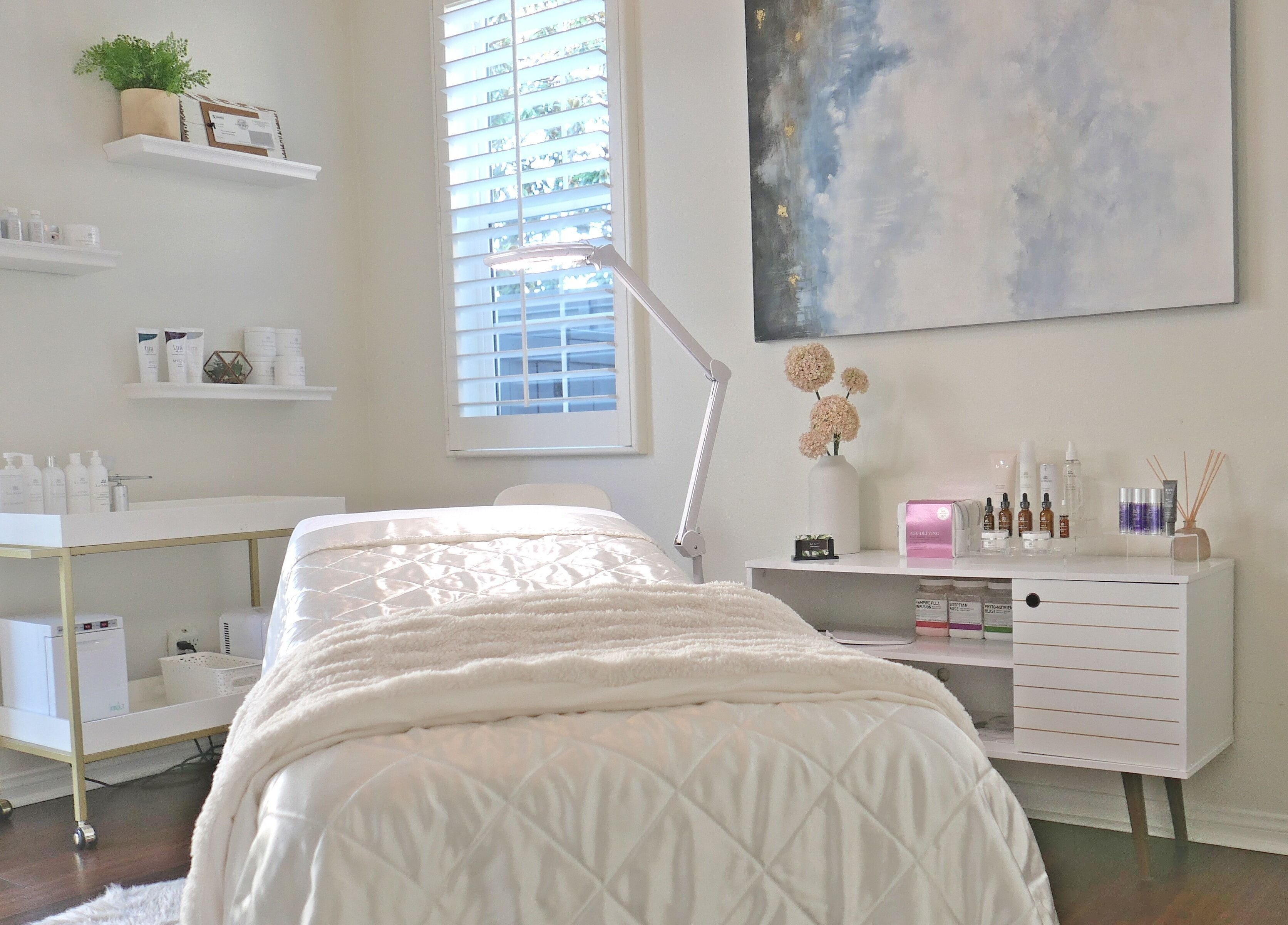 Calm treatment room at Refresh Skin in Carlsbad, California, US, featuring a plush bed and serene decor.