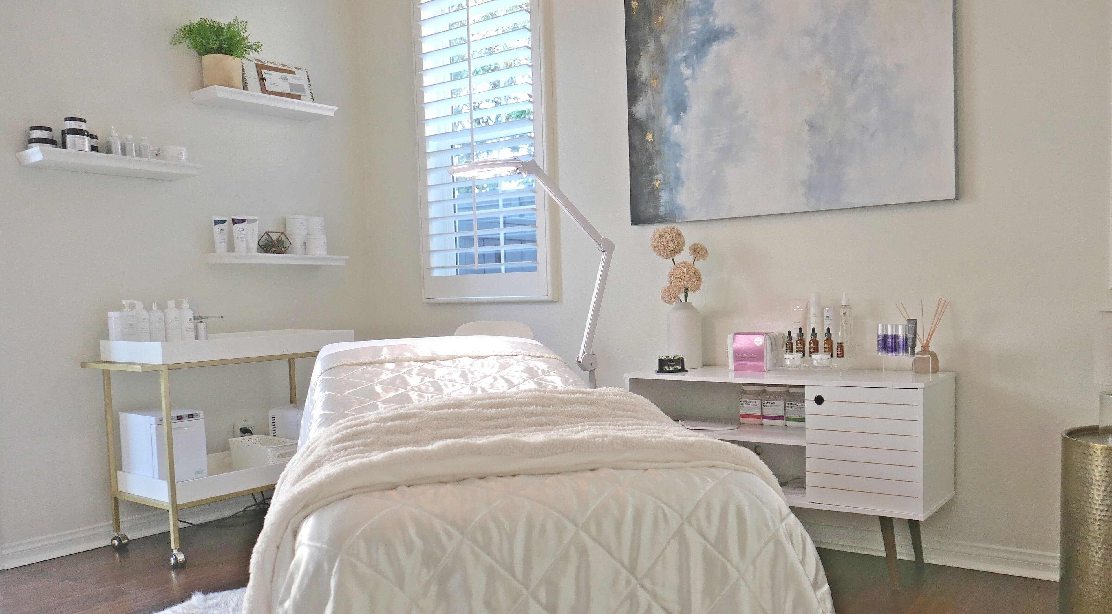 Calm treatment room at Refresh Skin in Carlsbad, California, US, featuring a plush bed and serene decor.
