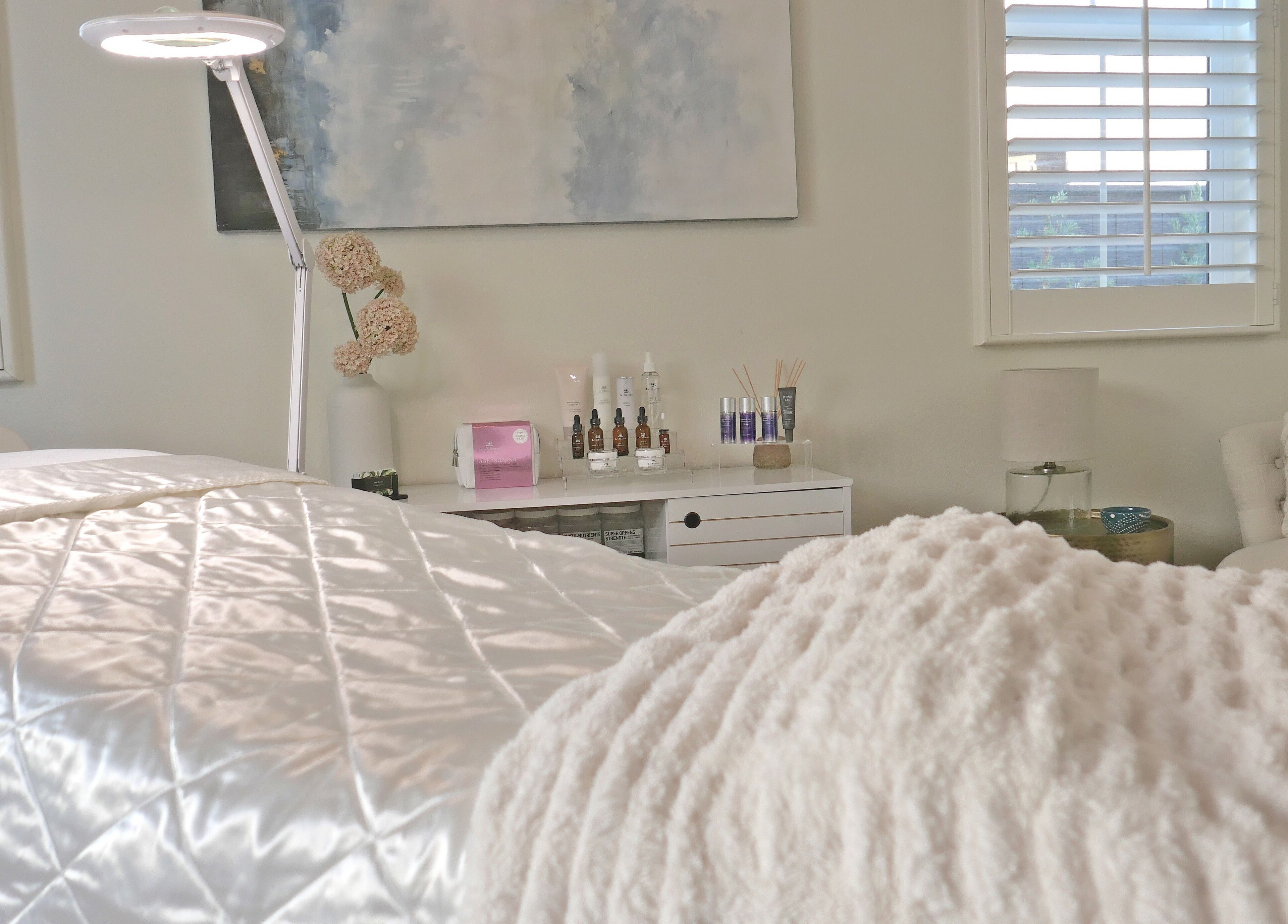 Cozy treatment room at Refresh Skin, Carlsbad, California, US, featuring soft light and skincare products.
