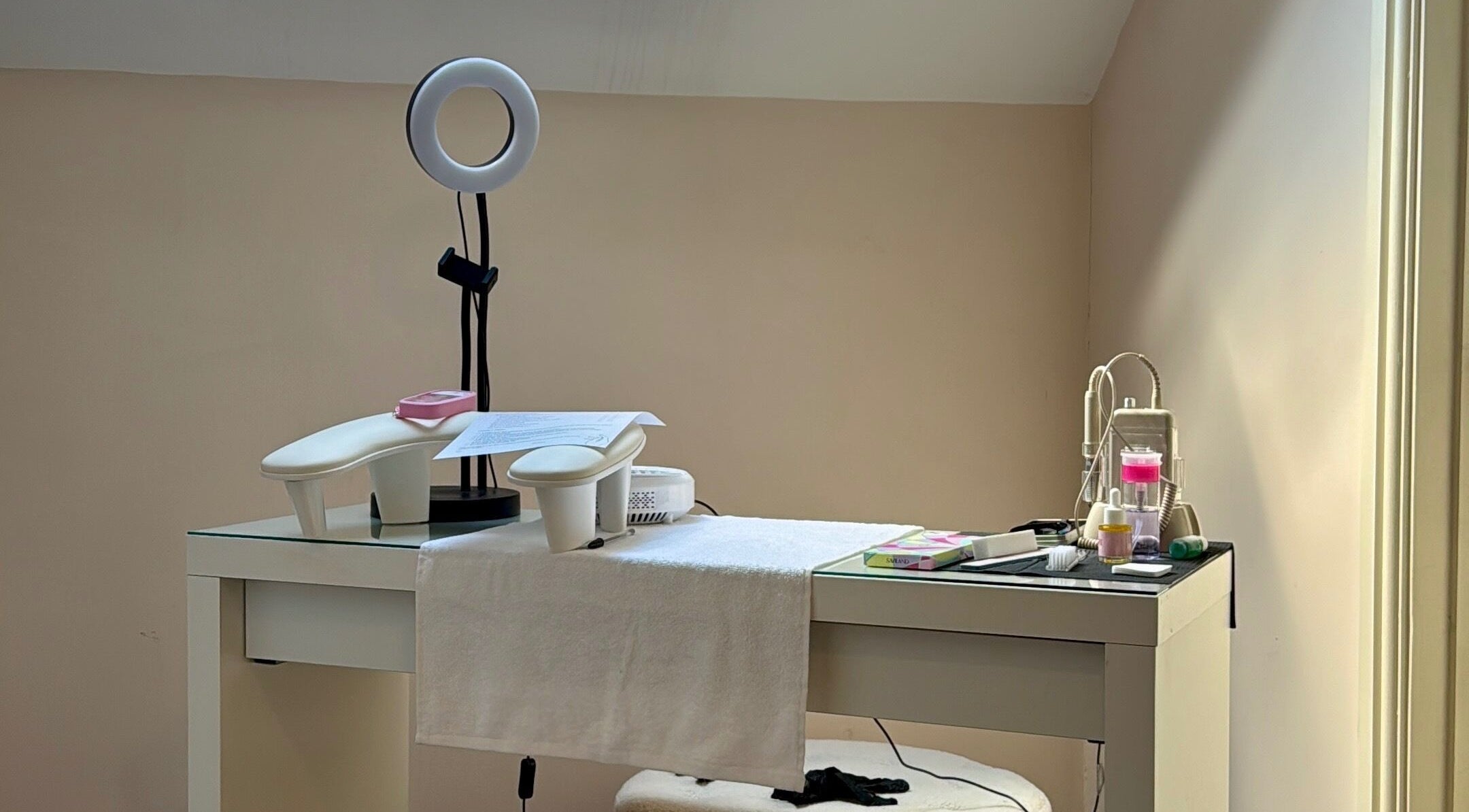 A professional manicure station at By Tilly, Chinnor, England, GB showcasing tools and a ring light.