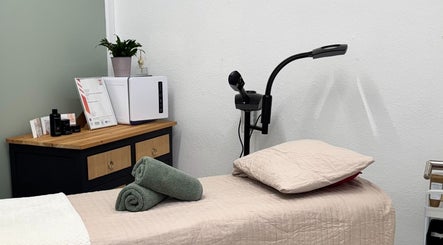 Relaxing spa room at The Beauty Feel With Iryna in Redruth, England, GB with massage table and cozy decor.