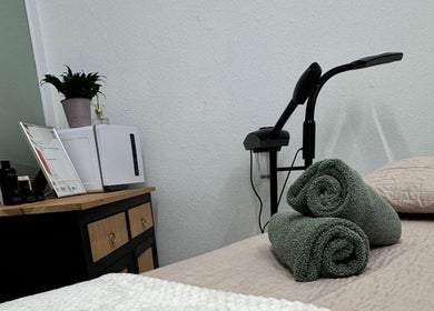 Relaxing spa table at The Beauty Feel With Iryna, Redruth, England, GB, featuring neatly folded towels.