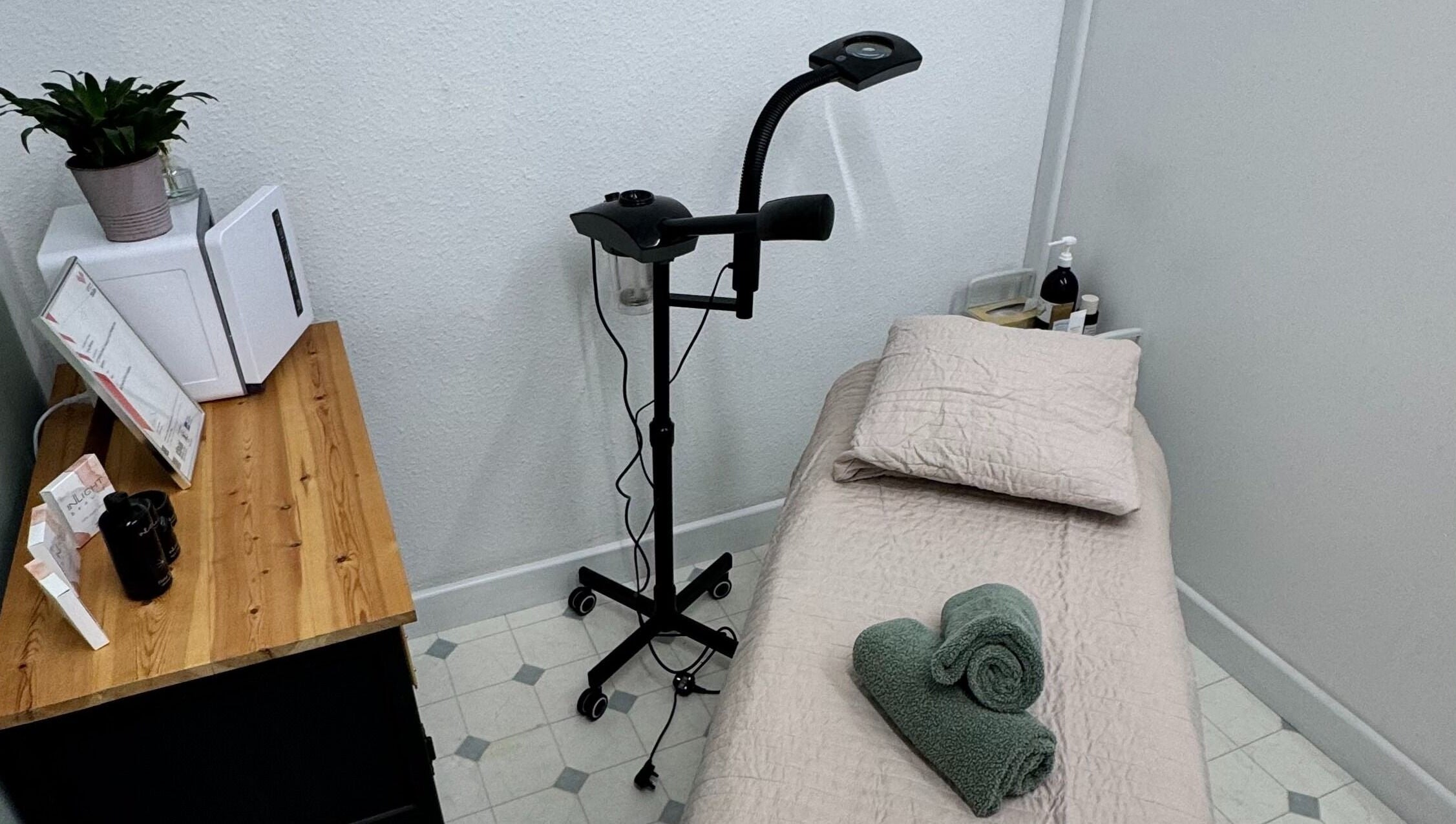 Cozy treatment room at The Beauty Feel With Iryna, Redruth, England. Relaxing setup with bed and green towels.