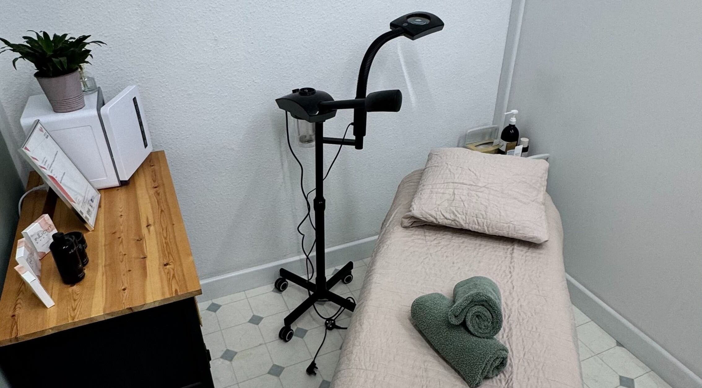 Cozy treatment room at The Beauty Feel With Iryna, Redruth, England. Relaxing setup with bed and green towels.