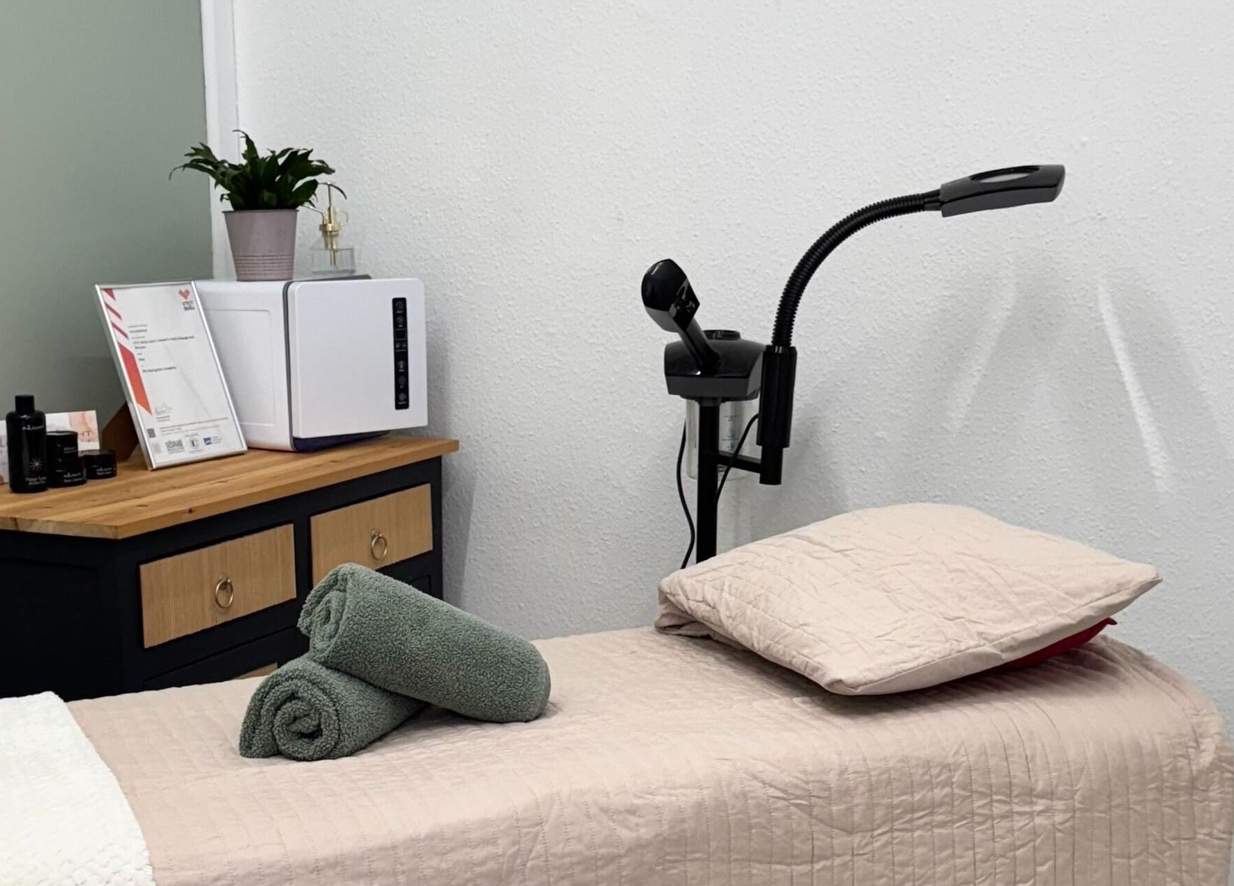 Relaxing treatment room at The Beauty Feel With Iryna, Redruth, England, GB featuring a comfortable massage bed.