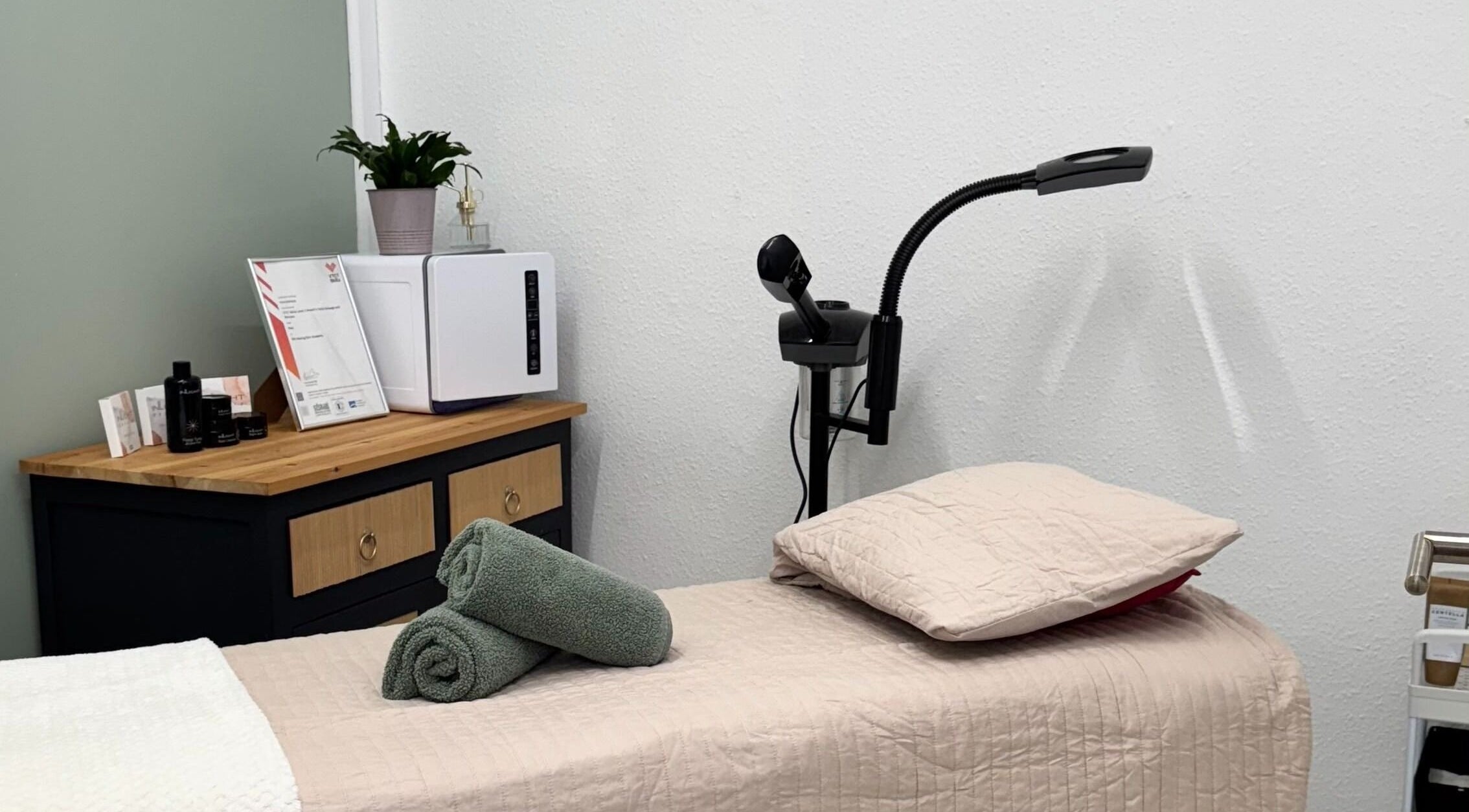 Relaxing treatment room at The Beauty Feel With Iryna, Redruth, England, GB featuring a comfortable massage bed.