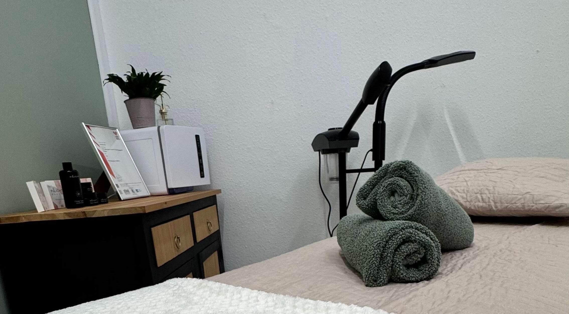 Massage table with folded towels at The Beauty Feel With Iryna, Redruth, England, GB.