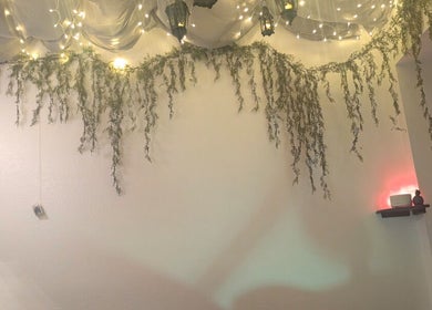 Ambient lighting with draped greenery at Rose Glow Spa, Thomasville, Georgia, US, creating a serene atmosphere.