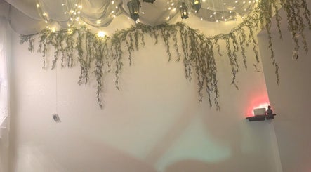 Ambient lighting with draped greenery at Rose Glow Spa, Thomasville, Georgia, US, creating a serene atmosphere.