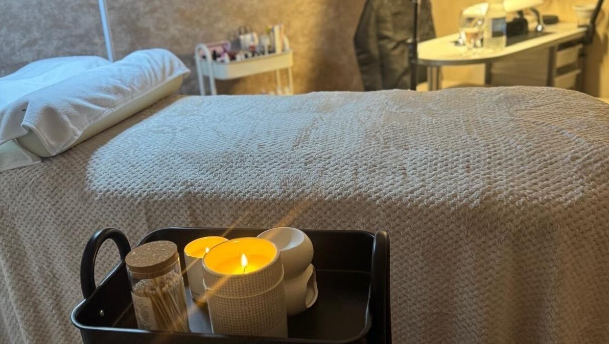 Relaxing treatment room at K&S Beauty & Aesthetics in Redditch, England, GB featuring candles and soft bedding.