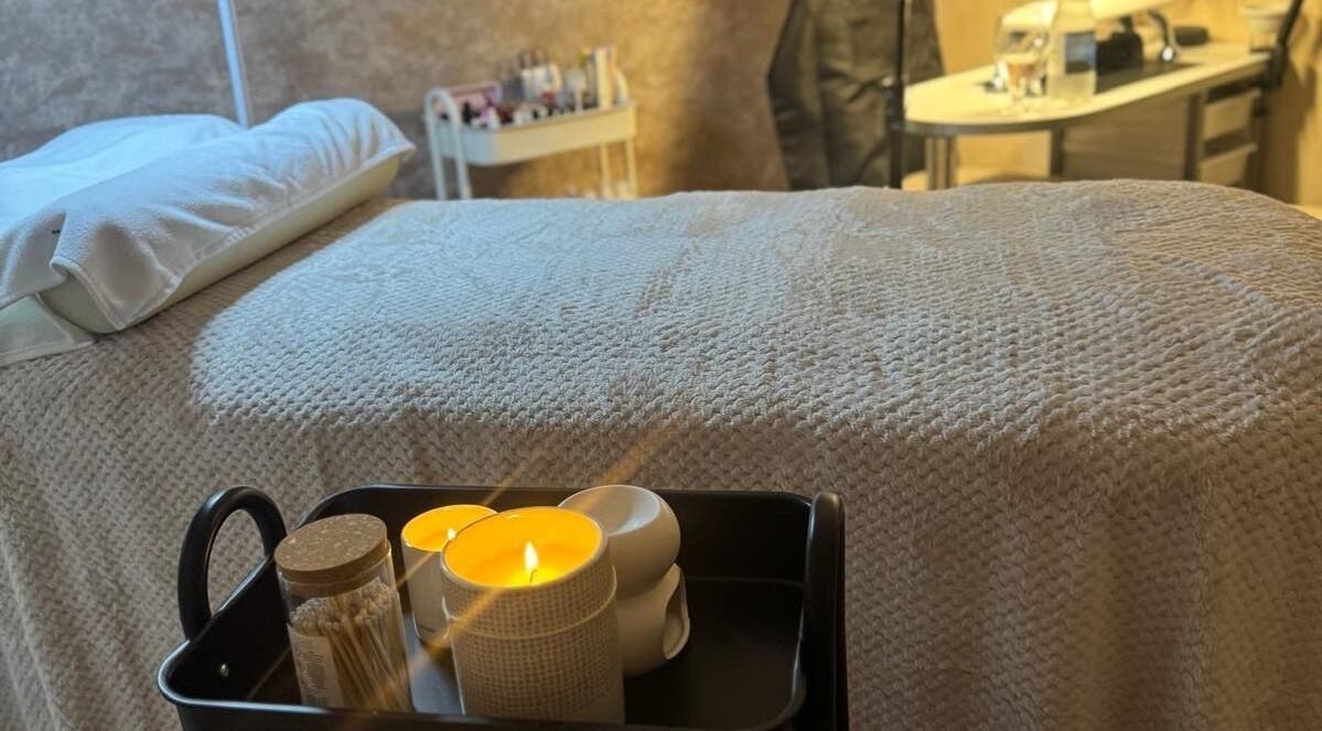 Relaxing treatment room at K&S Beauty & Aesthetics in Redditch, England, GB featuring candles and soft bedding.