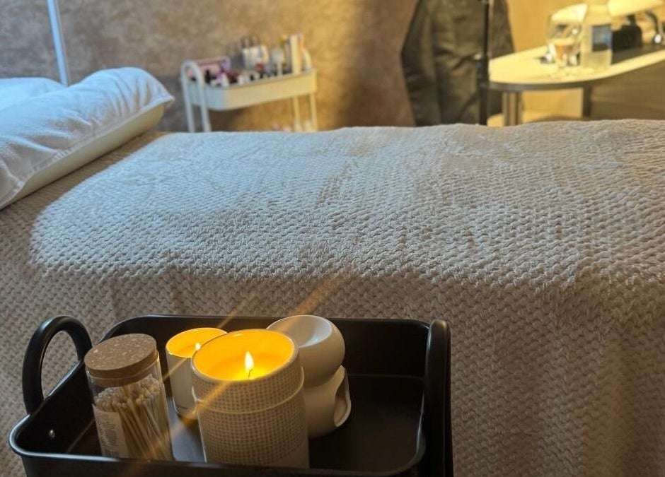 Tranquil treatment room at K&S Beauty & Aesthetics, Redditch, England, GB with candles and soft bedding.