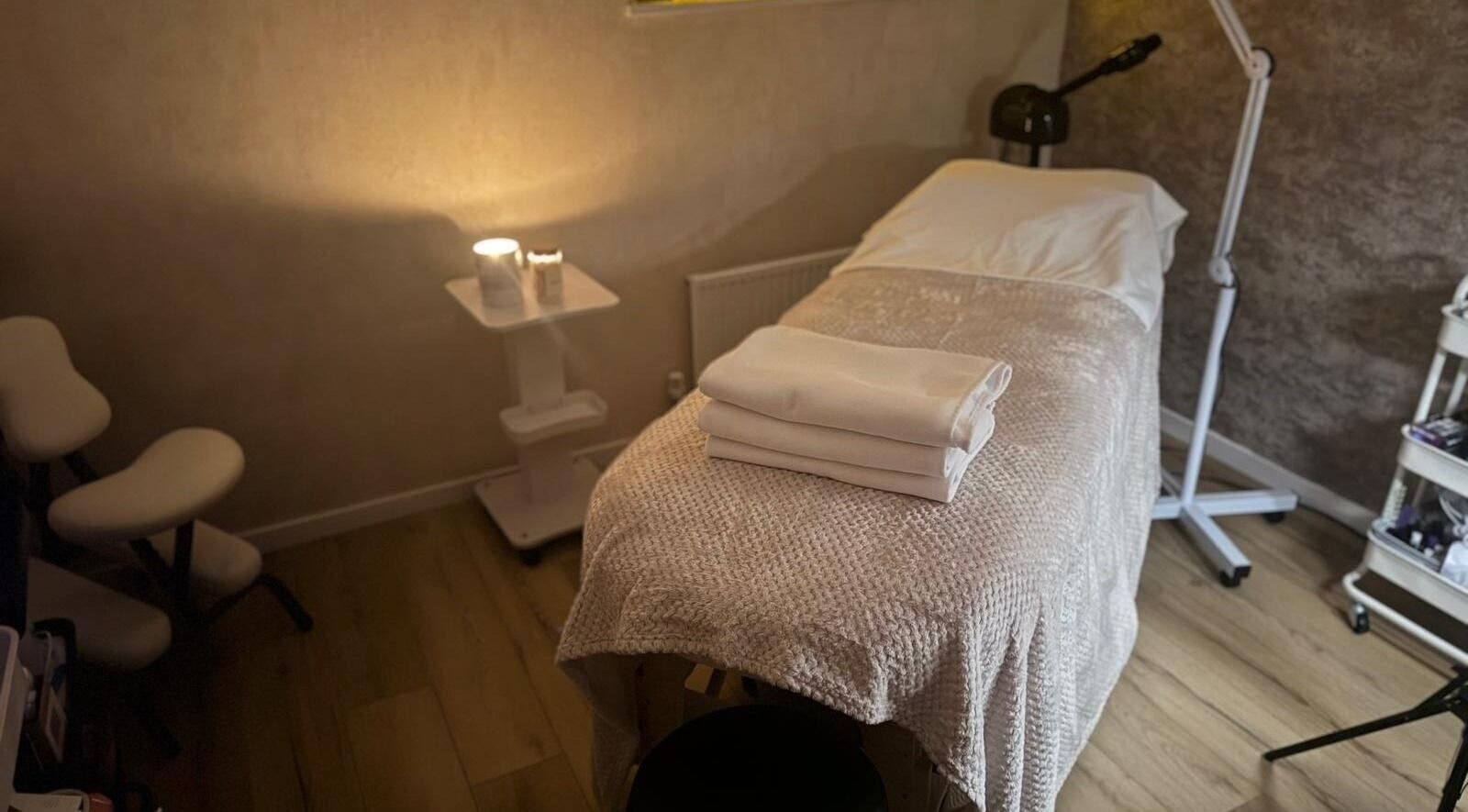 Spa treatment room at K&S Beauty & Aesthetics, Redditch, England, GB, with a cozy massage table and soft lighting.