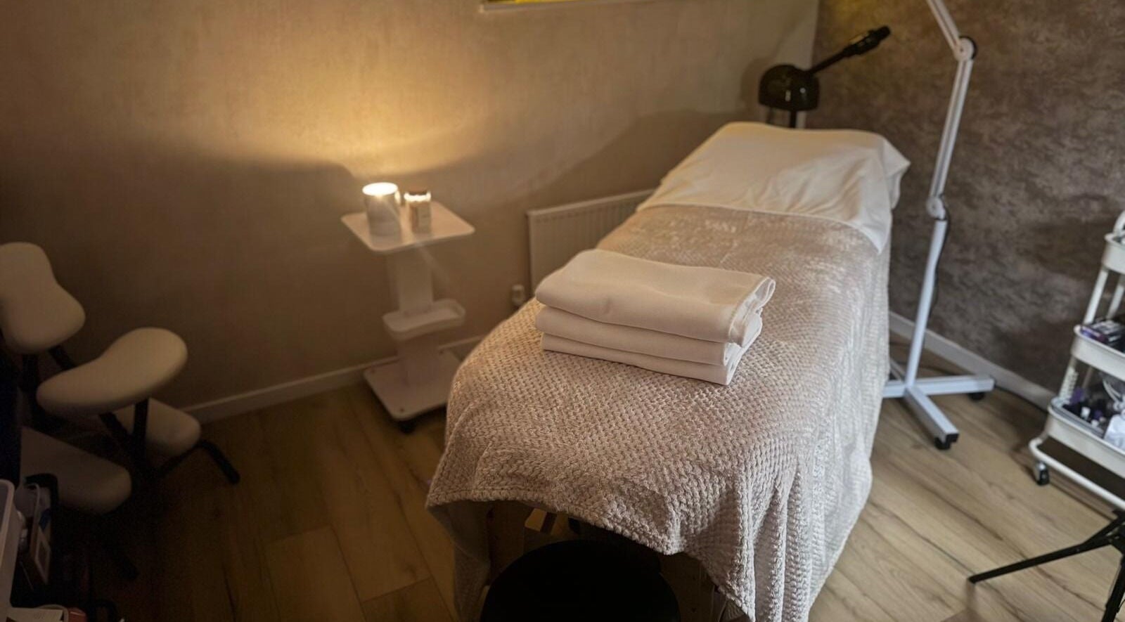 Spa treatment room at K&S Beauty & Aesthetics, Redditch, England, GB, with a cozy massage table and soft lighting.