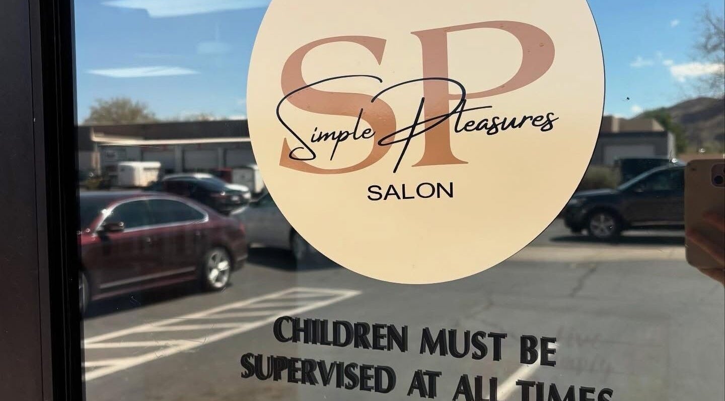 Entrance of KT Perfectly Polished salon in Hurricane, Utah, showing window decal with hours and name.