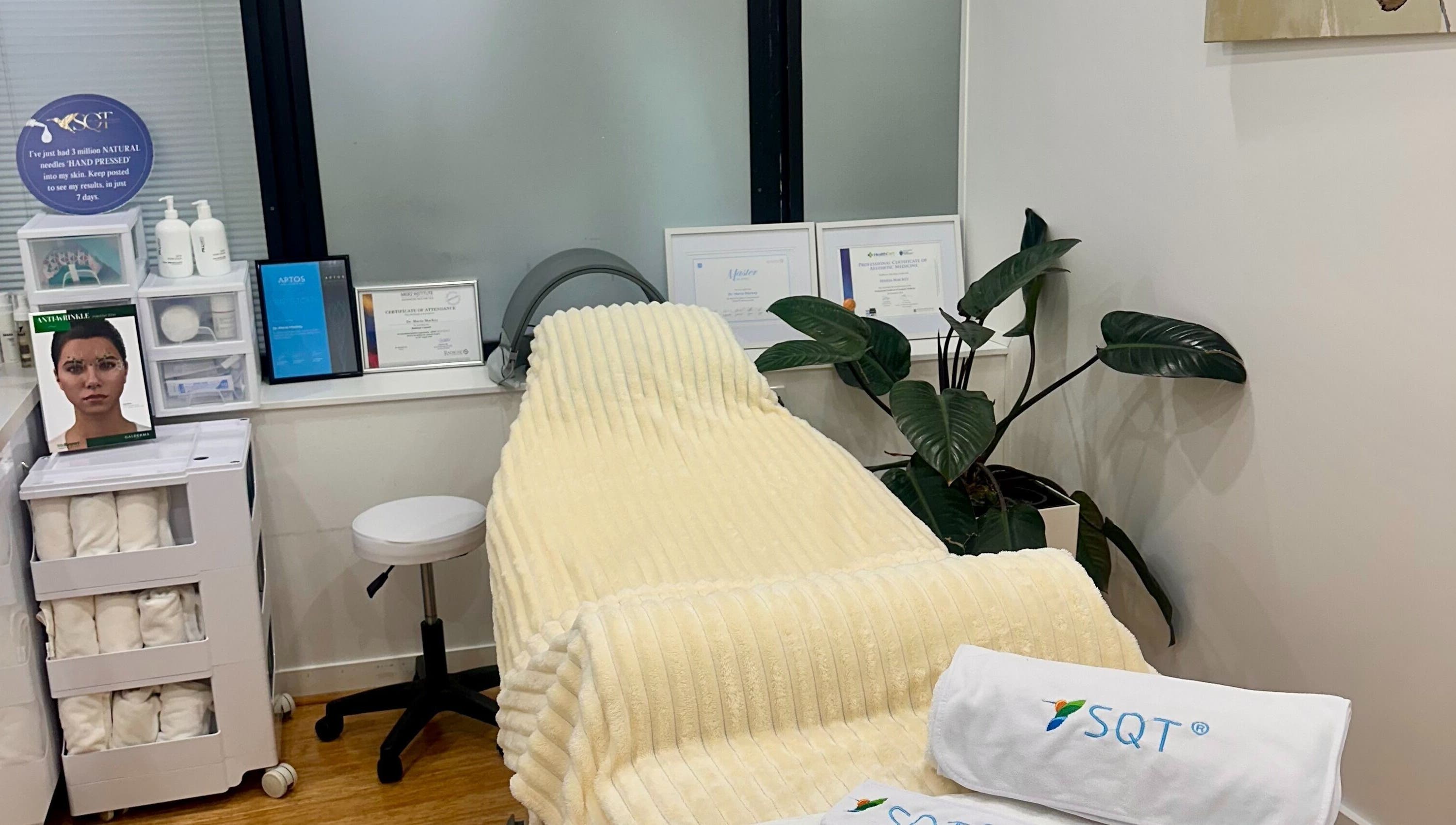Serene treatment room at Mojo Cosmetic Clinic, Neutral Bay, New South Wales, AU with a plush recliner and certificates.