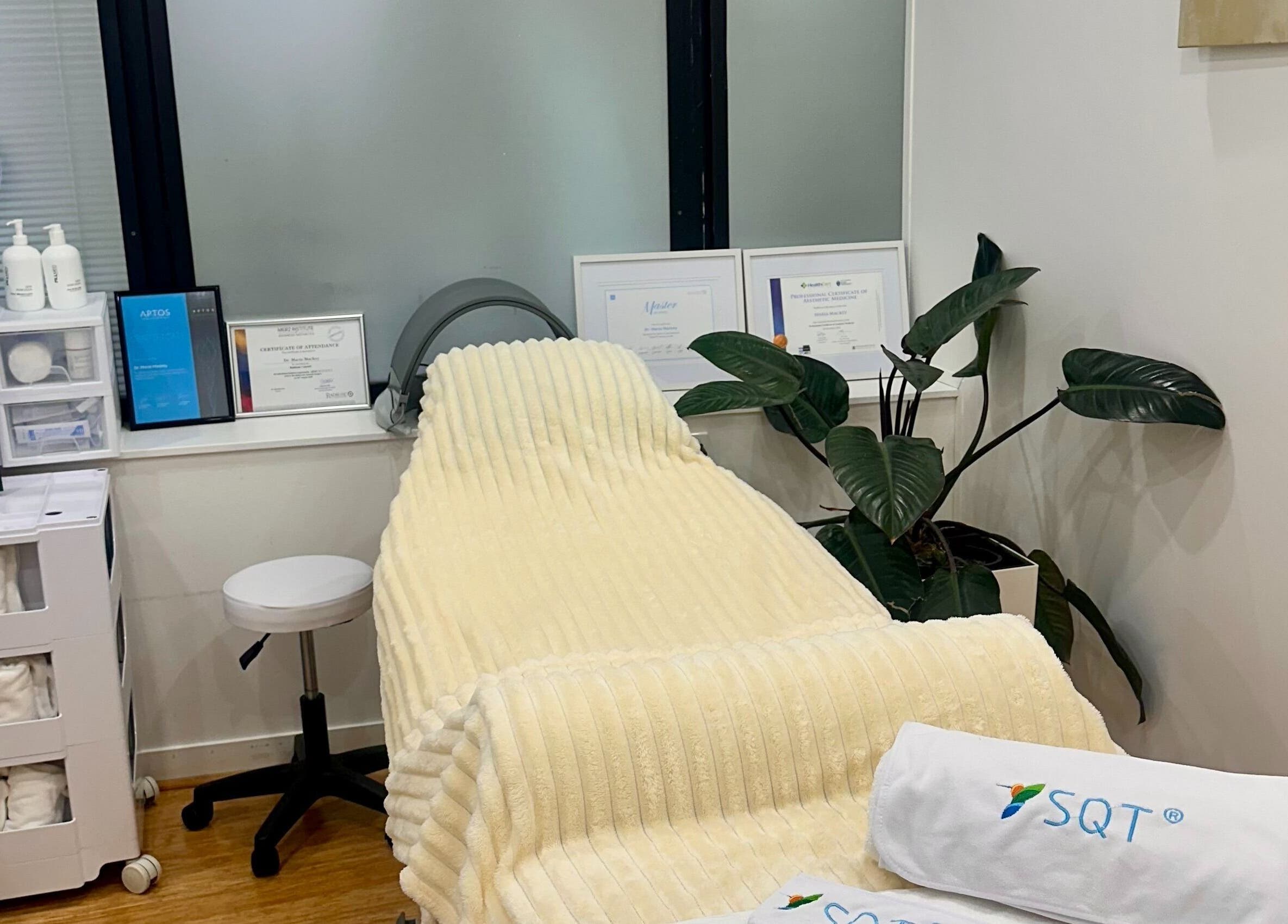 Serene treatment room at Mojo Cosmetic Clinic, Neutral Bay, New South Wales, AU with a plush recliner and certificates.