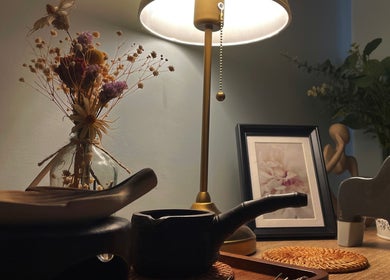 A serene decor setup at Pearl BodyCare in Bunbury, Western Australia, AU, featuring elegant flowers and soft lighting.