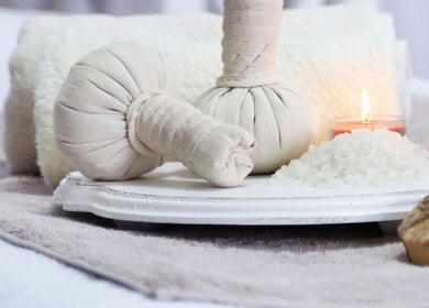 Relaxing spa setup with herbal compress and candles at Gaya Massage, Darlinghurst, New South Wales, AU.
