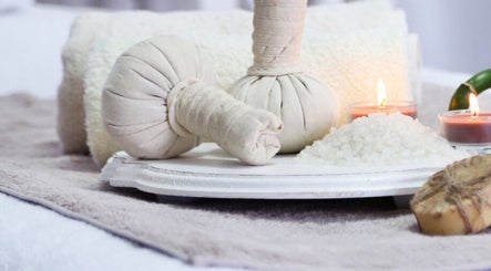 Relaxing spa setup with herbal compress and candles at Gaya Massage, Darlinghurst, New South Wales, AU.