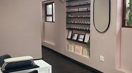 Interior of Alae Aesthetics & Cosmetics in Gqeberha, featuring a stylish nail polish display and mirror.