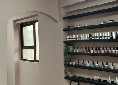 Nail polish display at Alae Aesthetics & Cosmetics, Gqeberha, Eastern Cape, ZA elegantly organized on shelves.