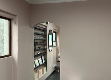 Stylish interior of Alae Aesthetics & Cosmetics in Gqeberha, Eastern Cape, ZA featuring elegant shelves and lighting.