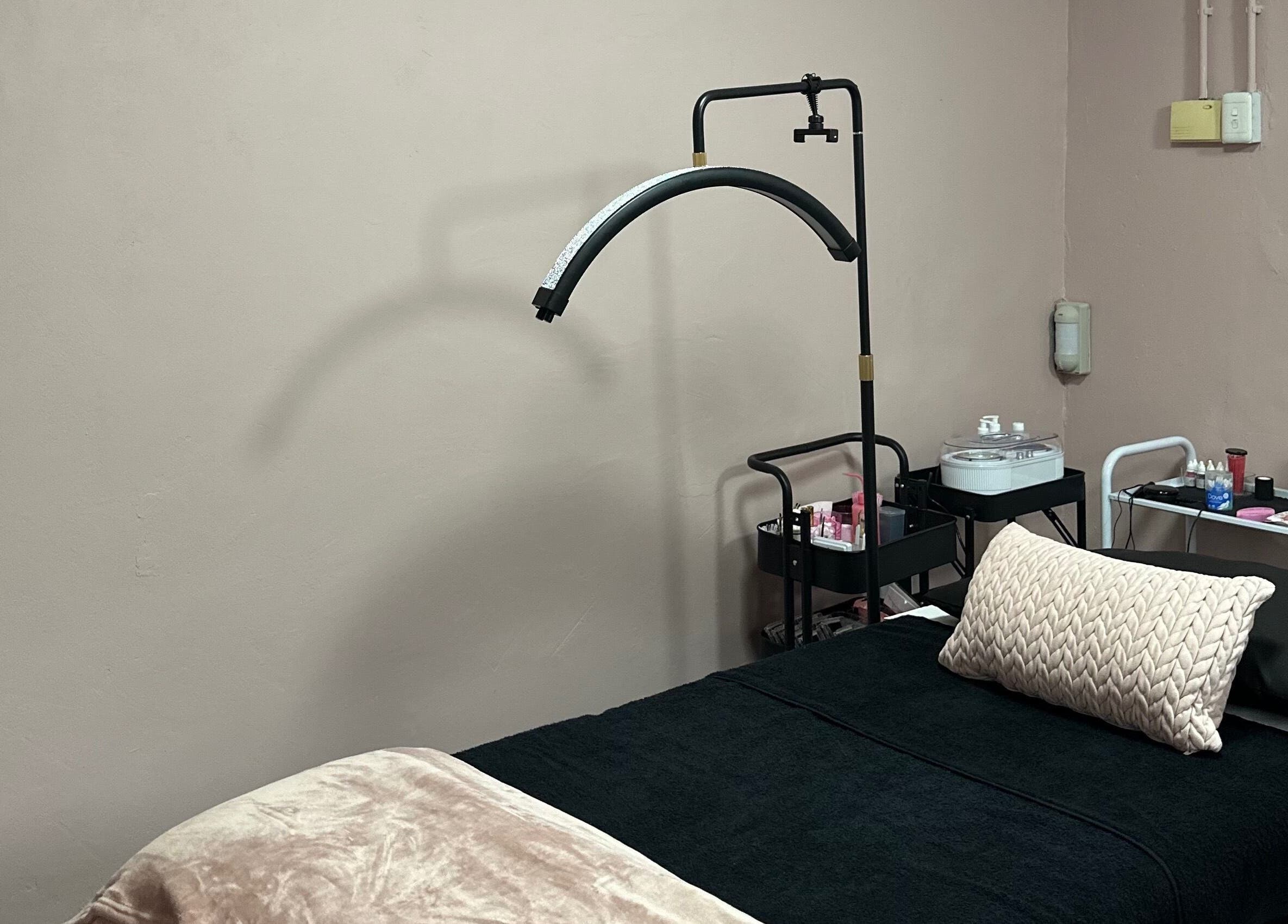 Calm treatment room at Alae Aesthetics & Cosmetics in Gqeberha, Eastern Cape, ZA, featuring a plush bed.