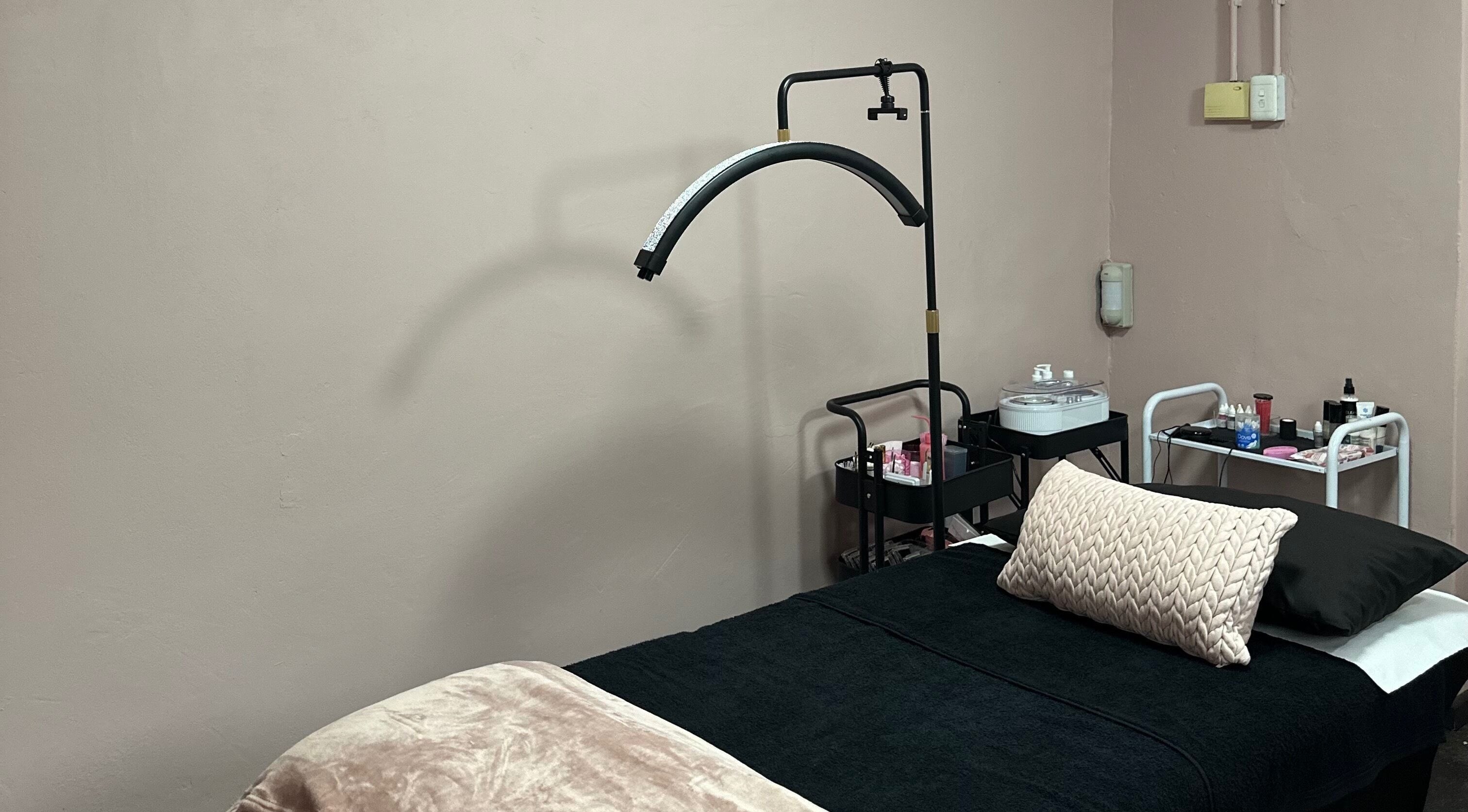 Calm treatment room at Alae Aesthetics & Cosmetics in Gqeberha, Eastern Cape, ZA, featuring a plush bed.