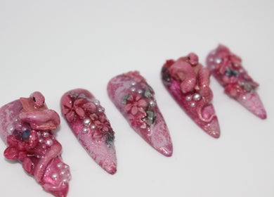Exquisite pink floral 3D nail art from Aurelia Nails by Miji, Male', MV, showcasing elegant craftsmanship.