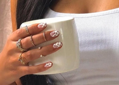 Elegant hand with checkered nails holding a mug at Gel By Shanice, Stirling, Western Australia, AU.